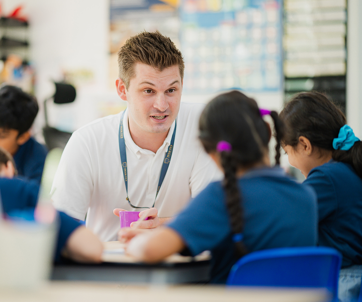Two students engaged in learning with a teacher
