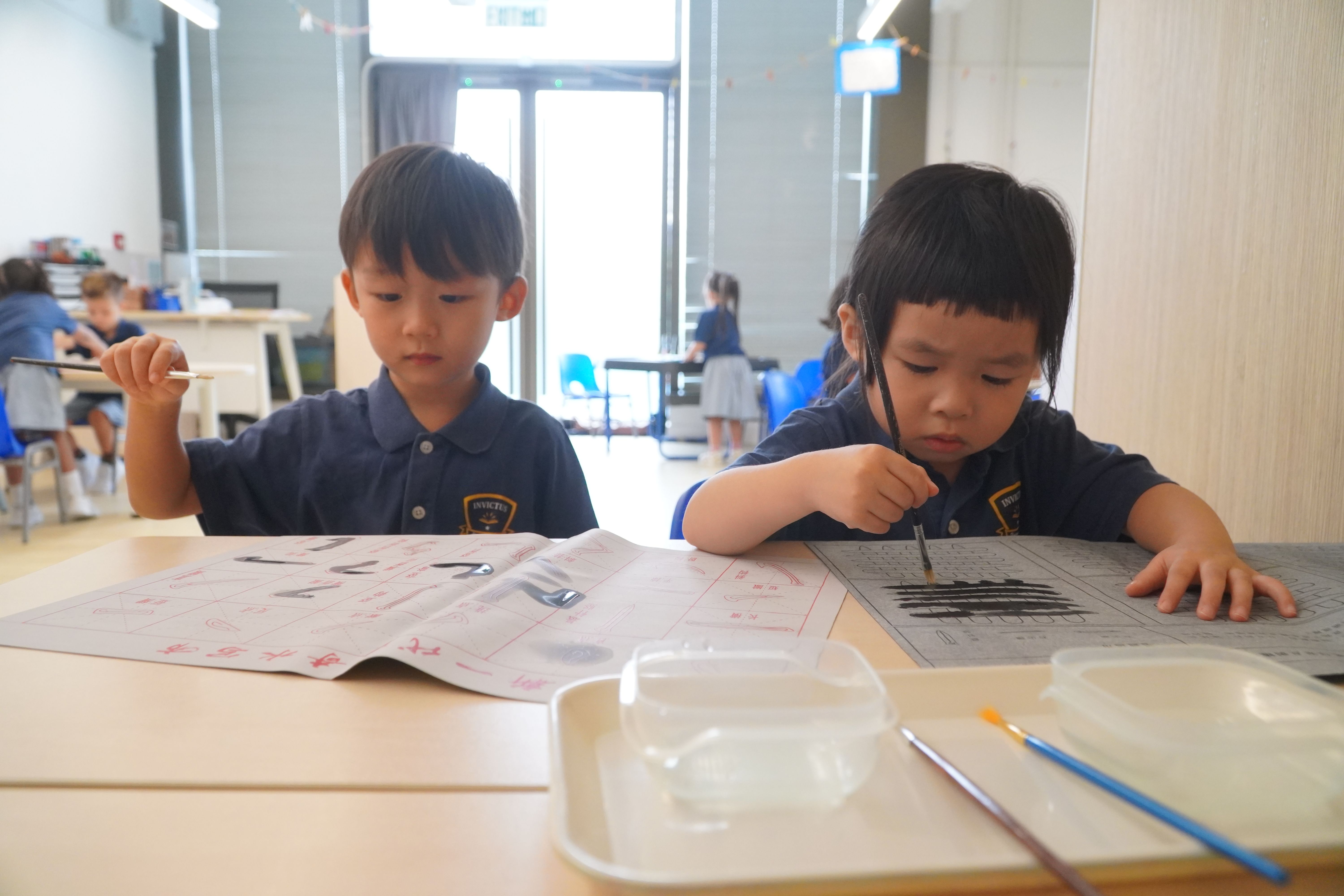 Students are writing chinese calligraphy.