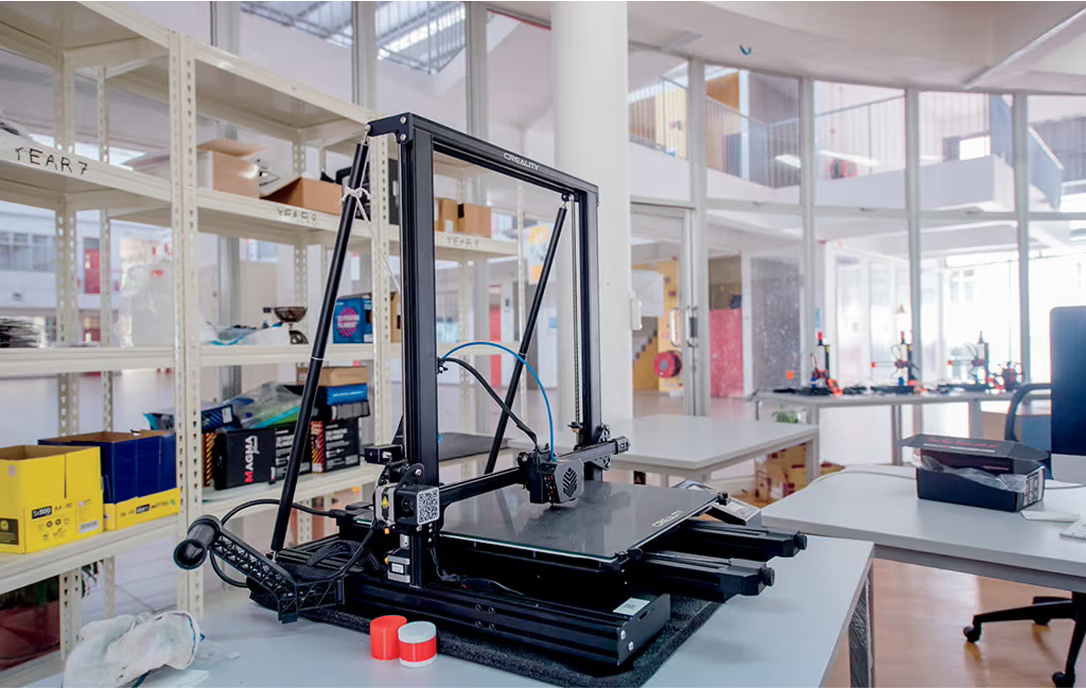 Innovative makerspace at Spring Hills Campus showcasing a 3D printer setup, supporting STEM learning and hands-on creativity.