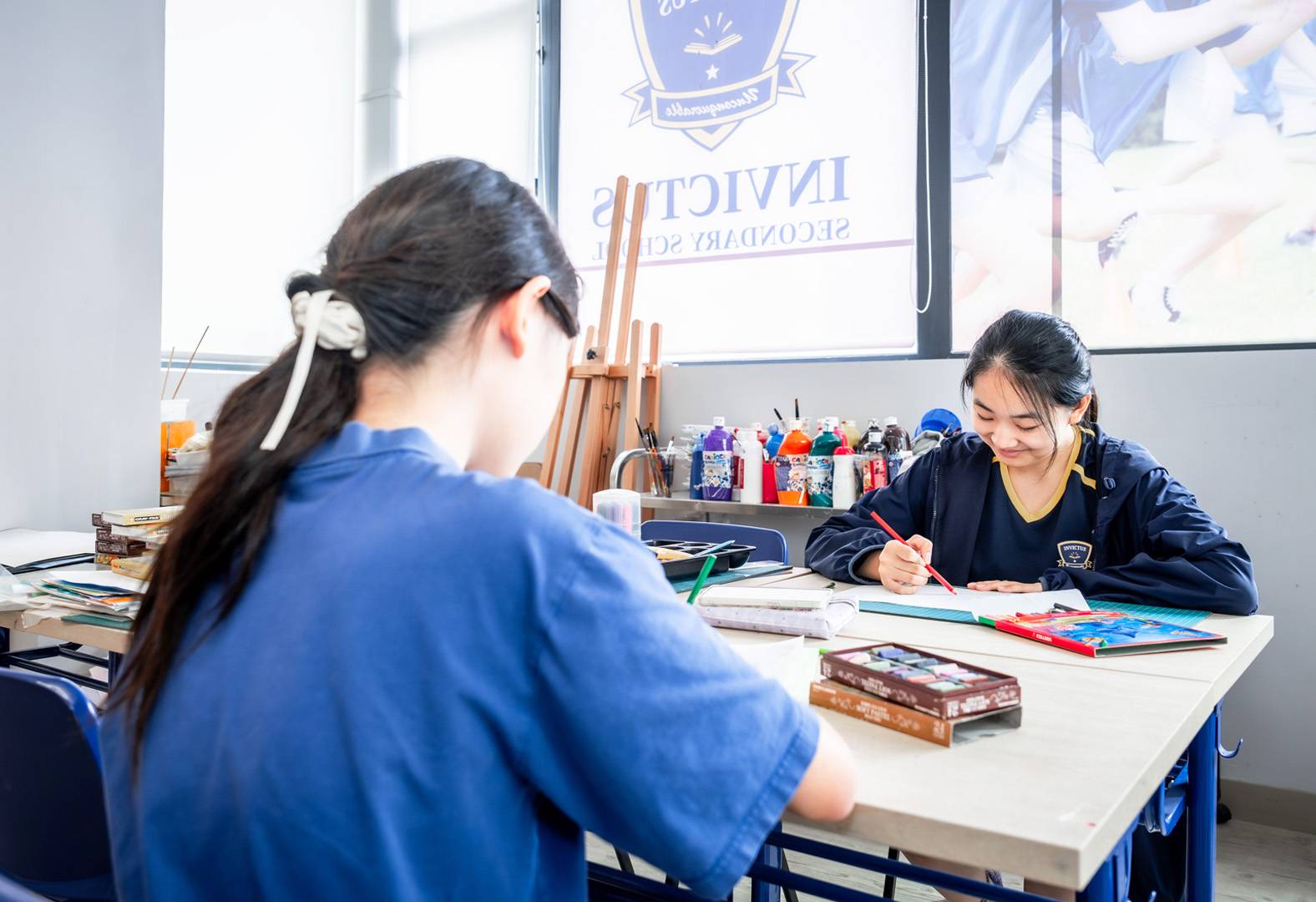 Four students reading a geography book