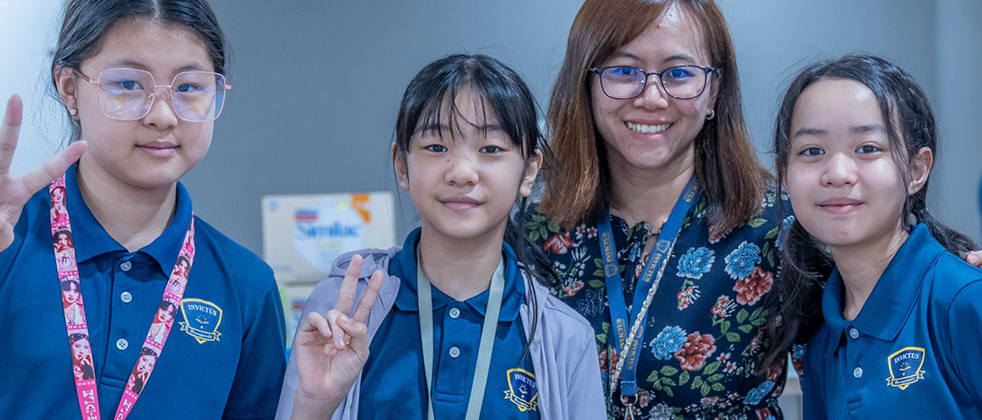 3 Invictus Students smiling with teacher