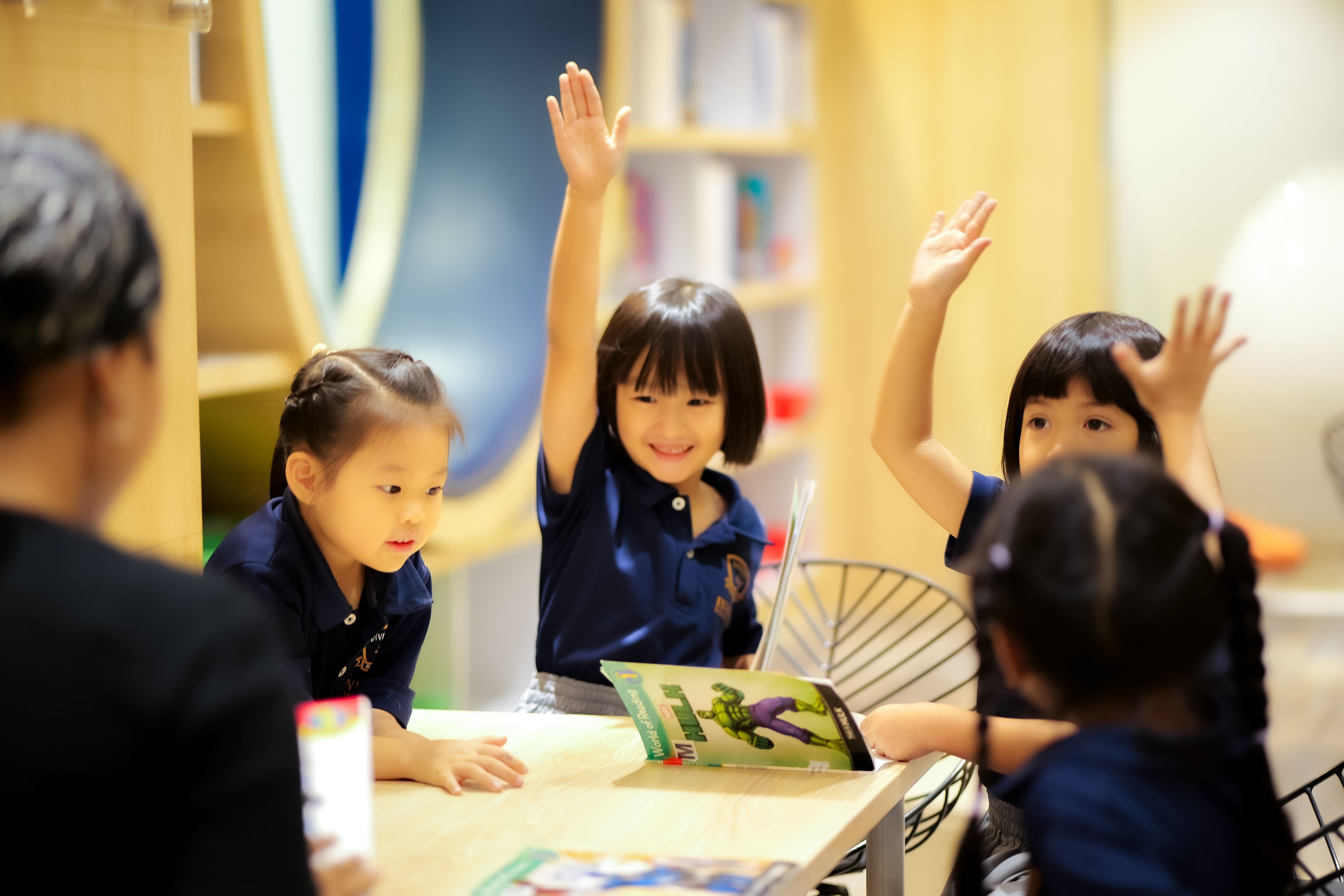 Two young students playing ukulele as part of a music lesson at Invictus Phnom Penh.