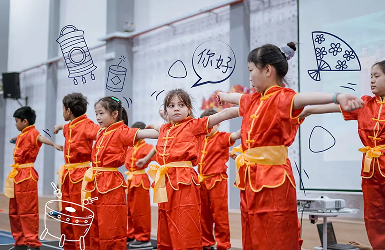 Students dressed in vibrant traditional Chinese outfits perform a cultural dance on stage, celebrating diversity and heritage at Invictus International School.