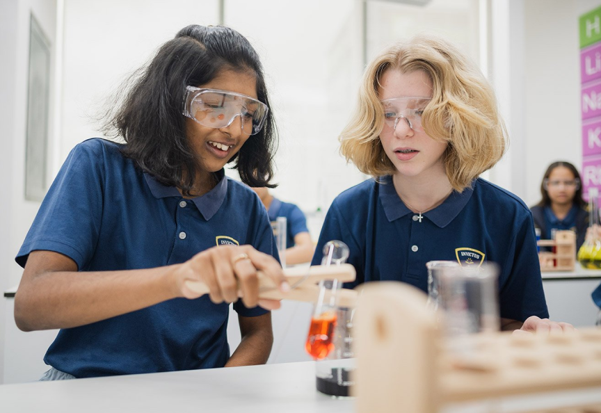Two children in a chemistry lab holding a test tube
