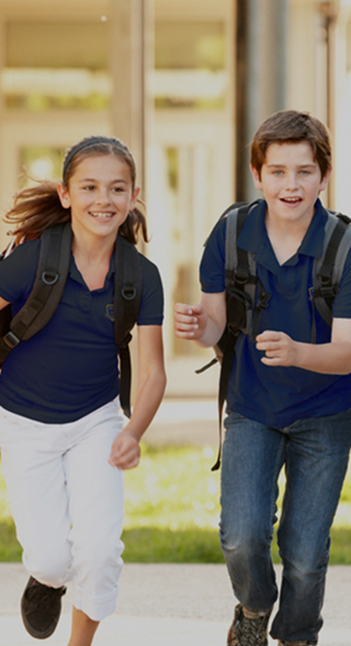 Invictus students happily running towards camera with backpack
