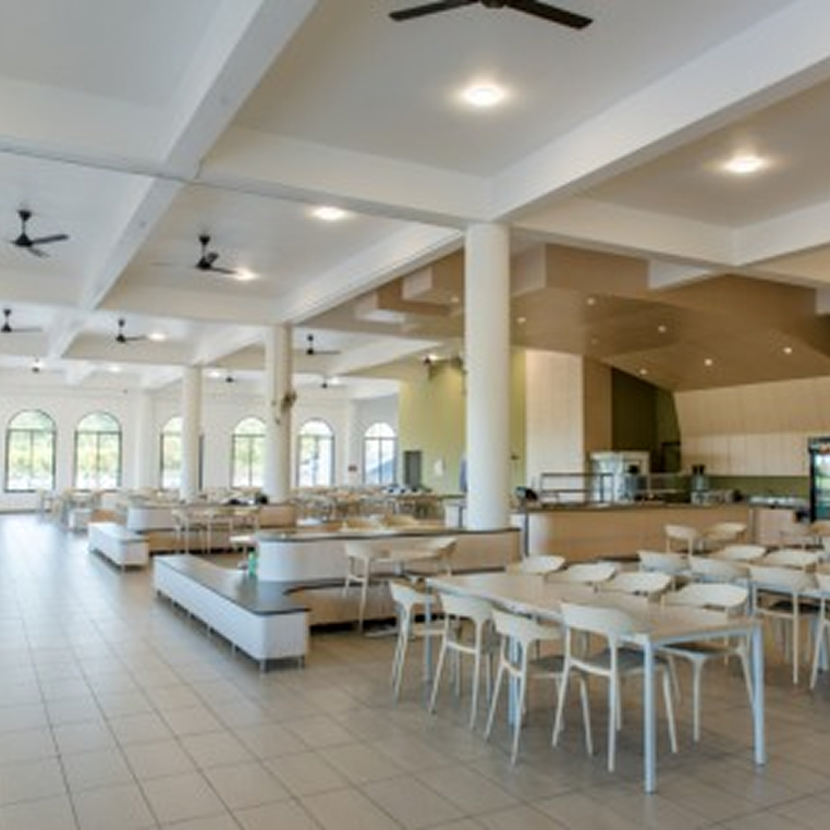 Invictus International School Malaysia Spring Hills Campus bright cafeteria with rows of tables and chairs