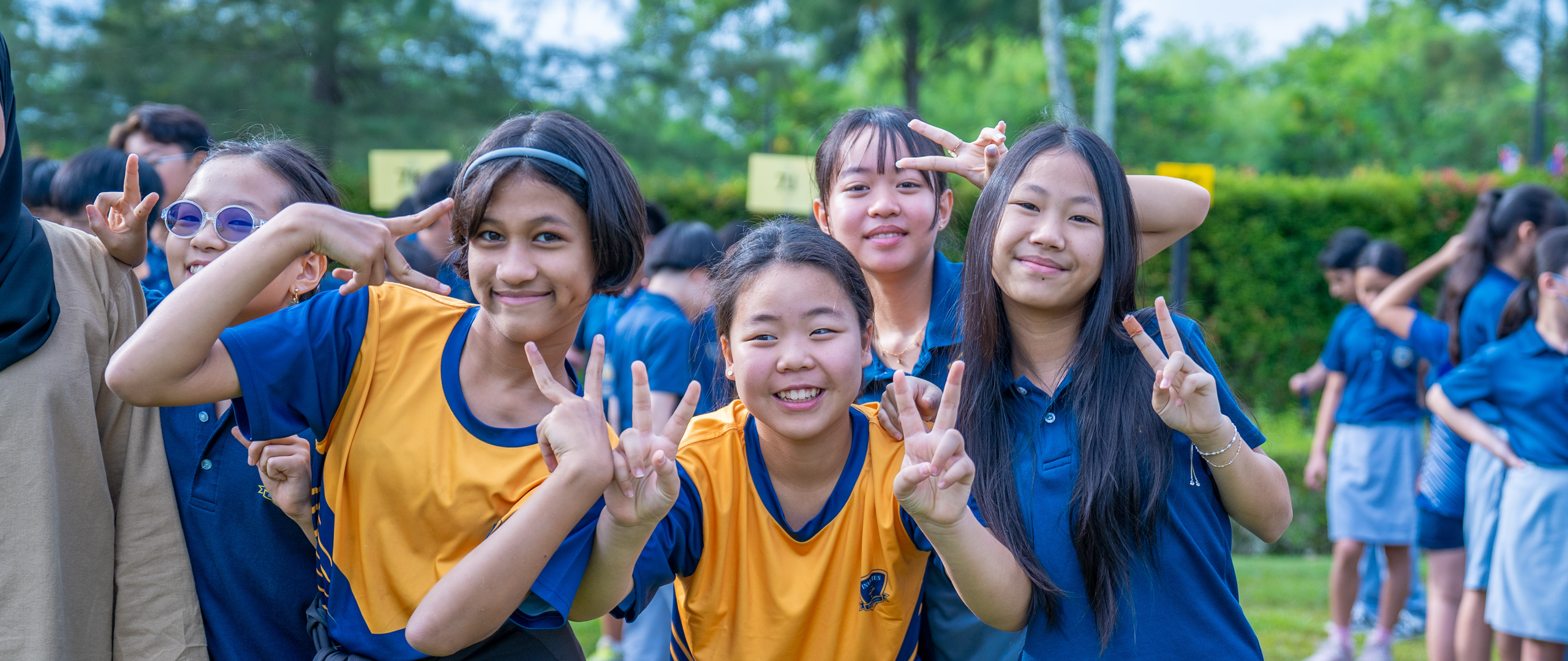 Students at Invictus Horizon Hills Malaysia enjoying outdoor activities with teachers, reflecting the joyful and diverse spirit of the campus.