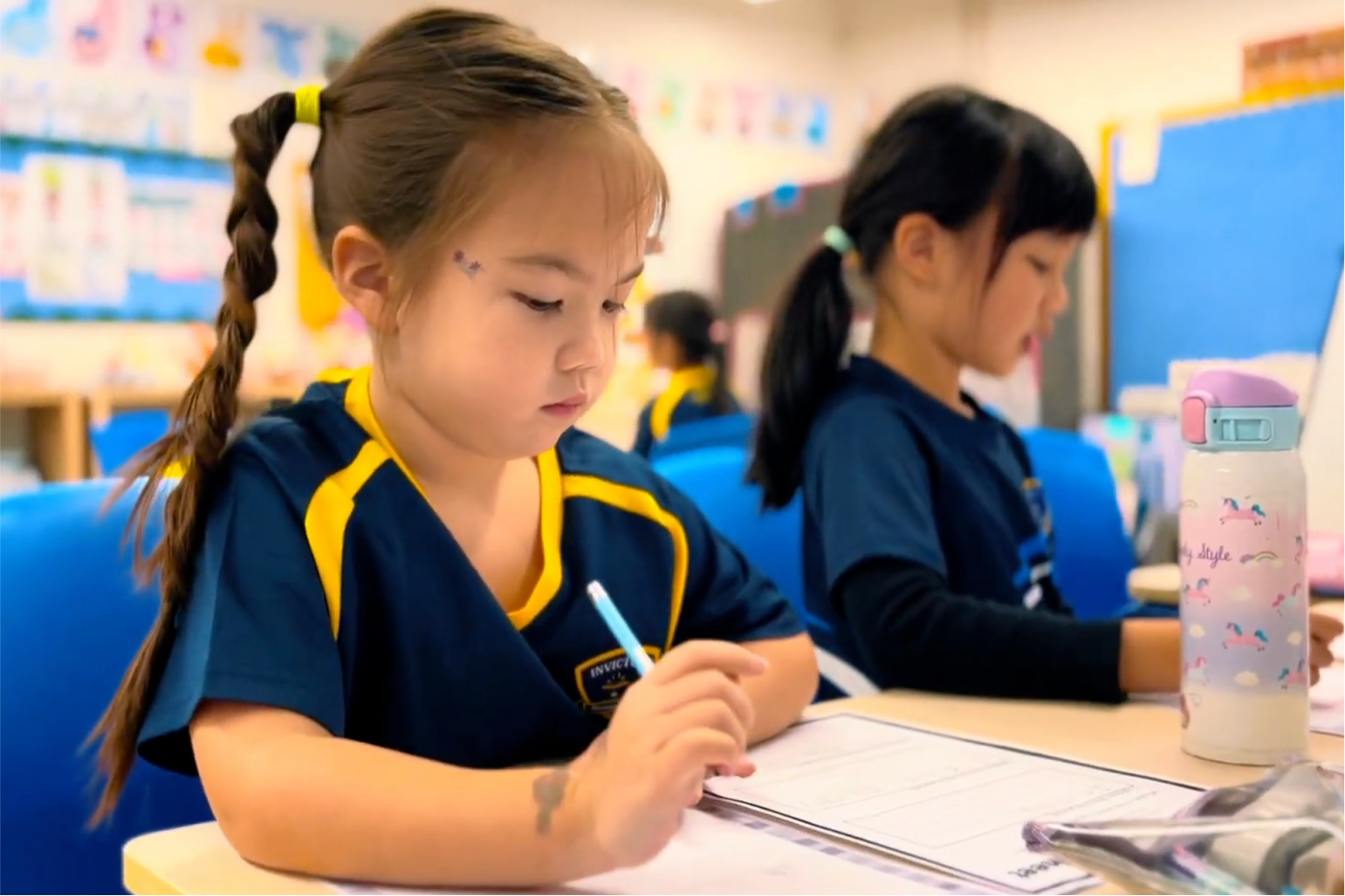 Two stduents with notebooks out in class