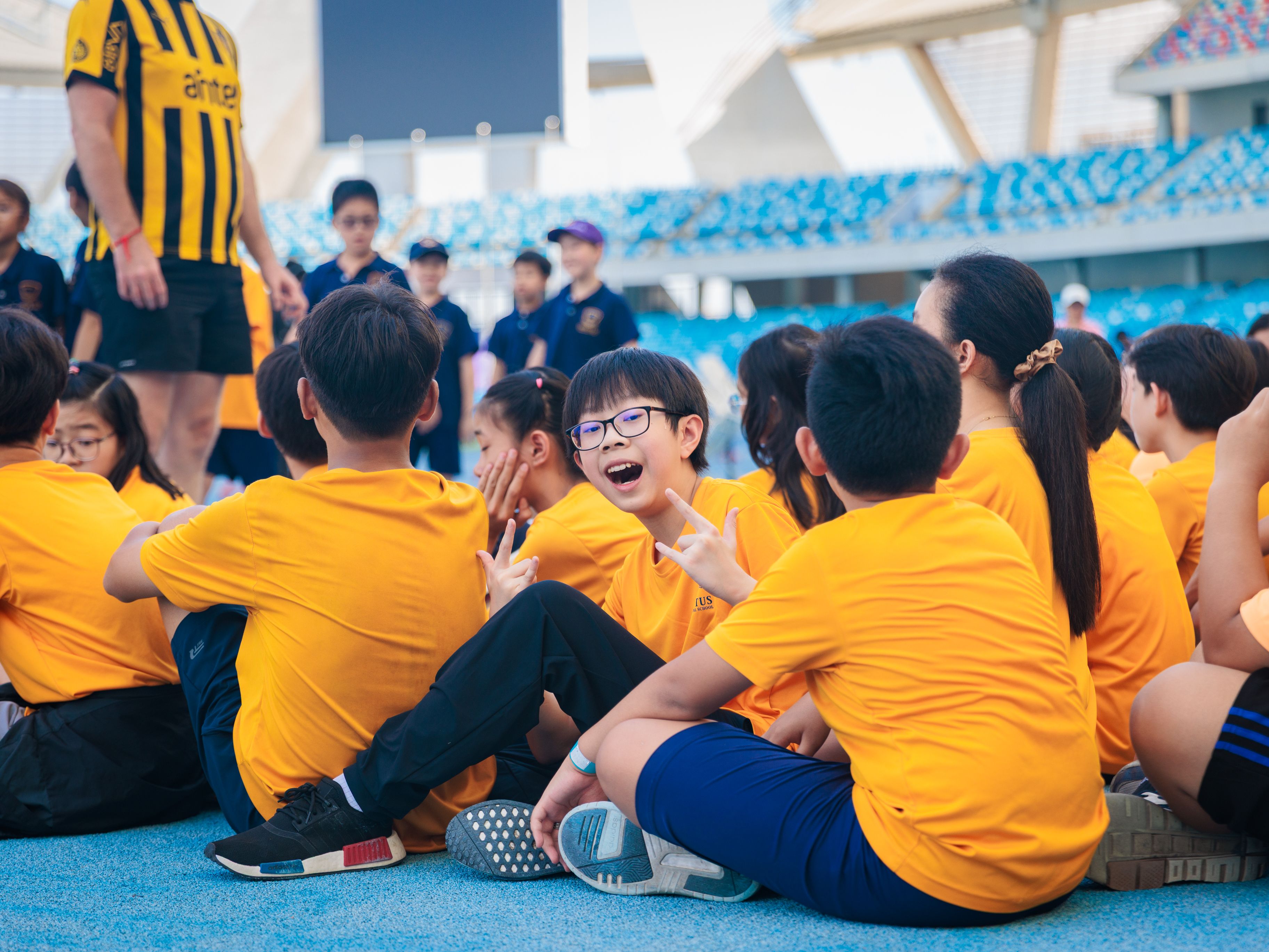 Secondary school girls in science lab coats conducting a chemistry experiment and smiling.