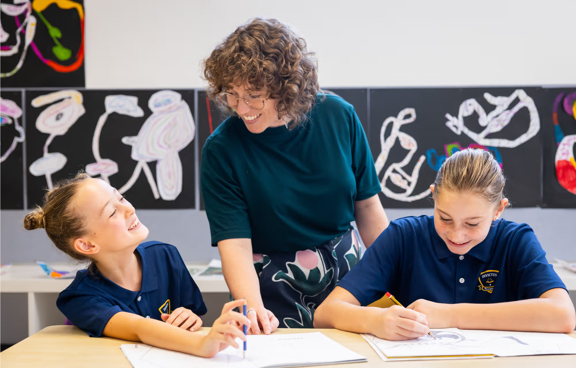 Teacher teaching two students