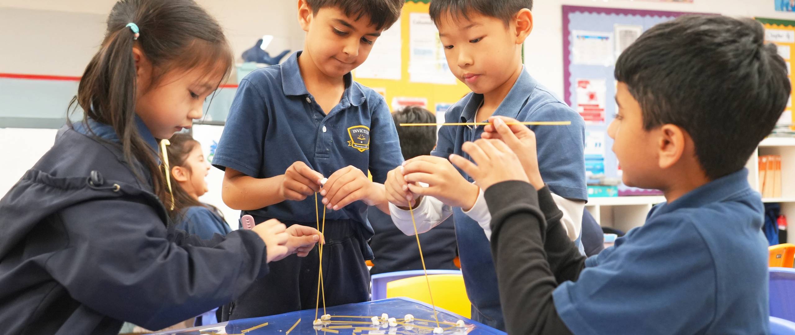 Students doing a science experiment in Invictus uniforms
