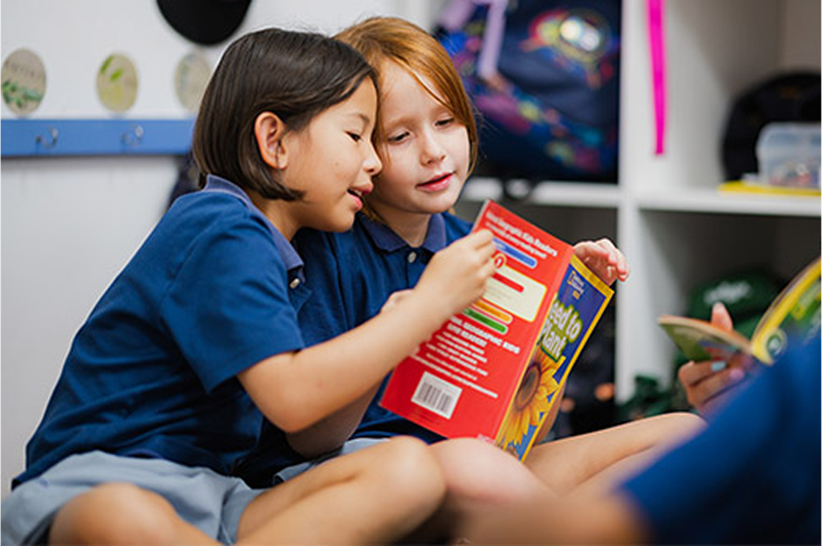 Two students reading a textbook together