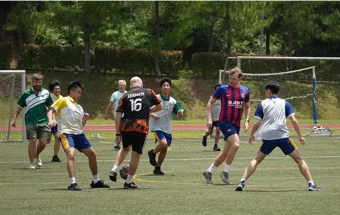 Students and teachers enjoying a friendly football match on the school’s outdoor field, promoting active lifestyles, teamwork, and fun at Invictus.