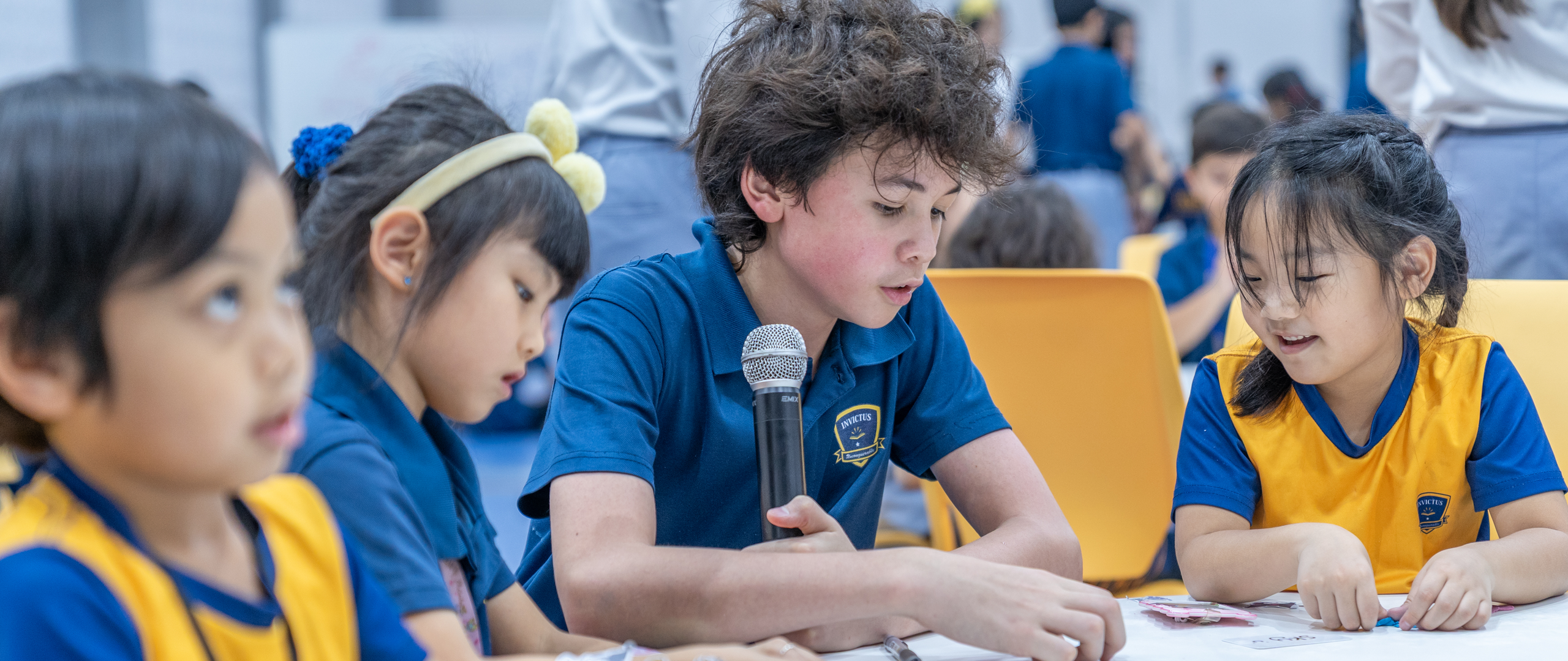 Students at Invictus Horizon Hills Malaysia enjoying outdoor activities with teachers, reflecting the joyful and diverse spirit of the campus.