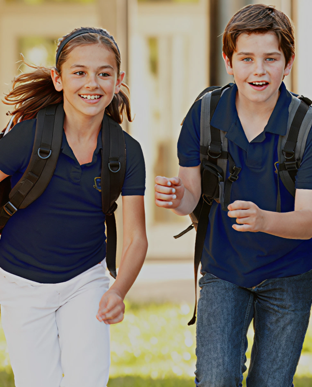 Image of two students wearing backpacks running