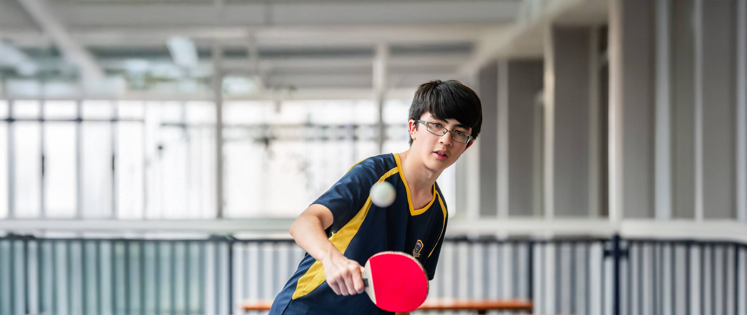 Secondary student playing table tennis