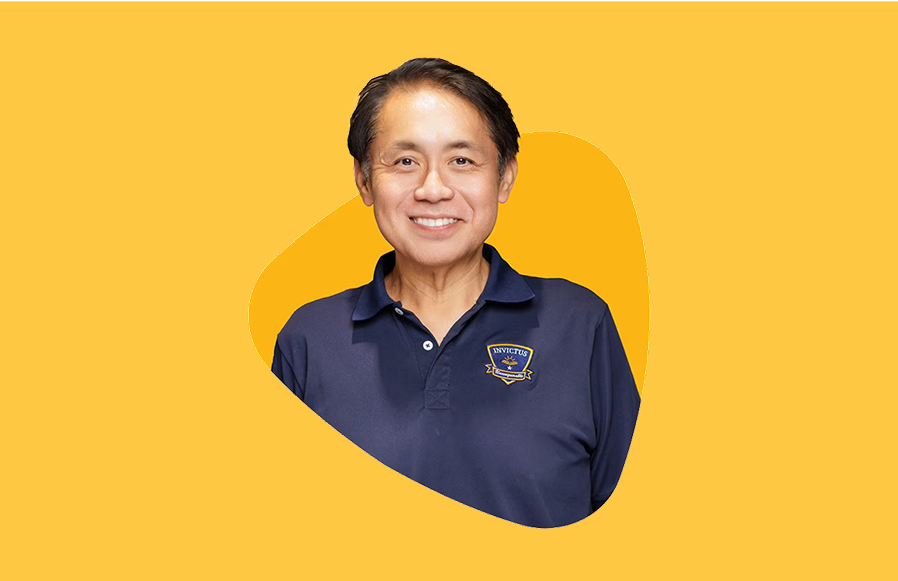 Portrait of Principal Mr. Martin Koh from Invictus Phnom Penh against a bright yellow background.