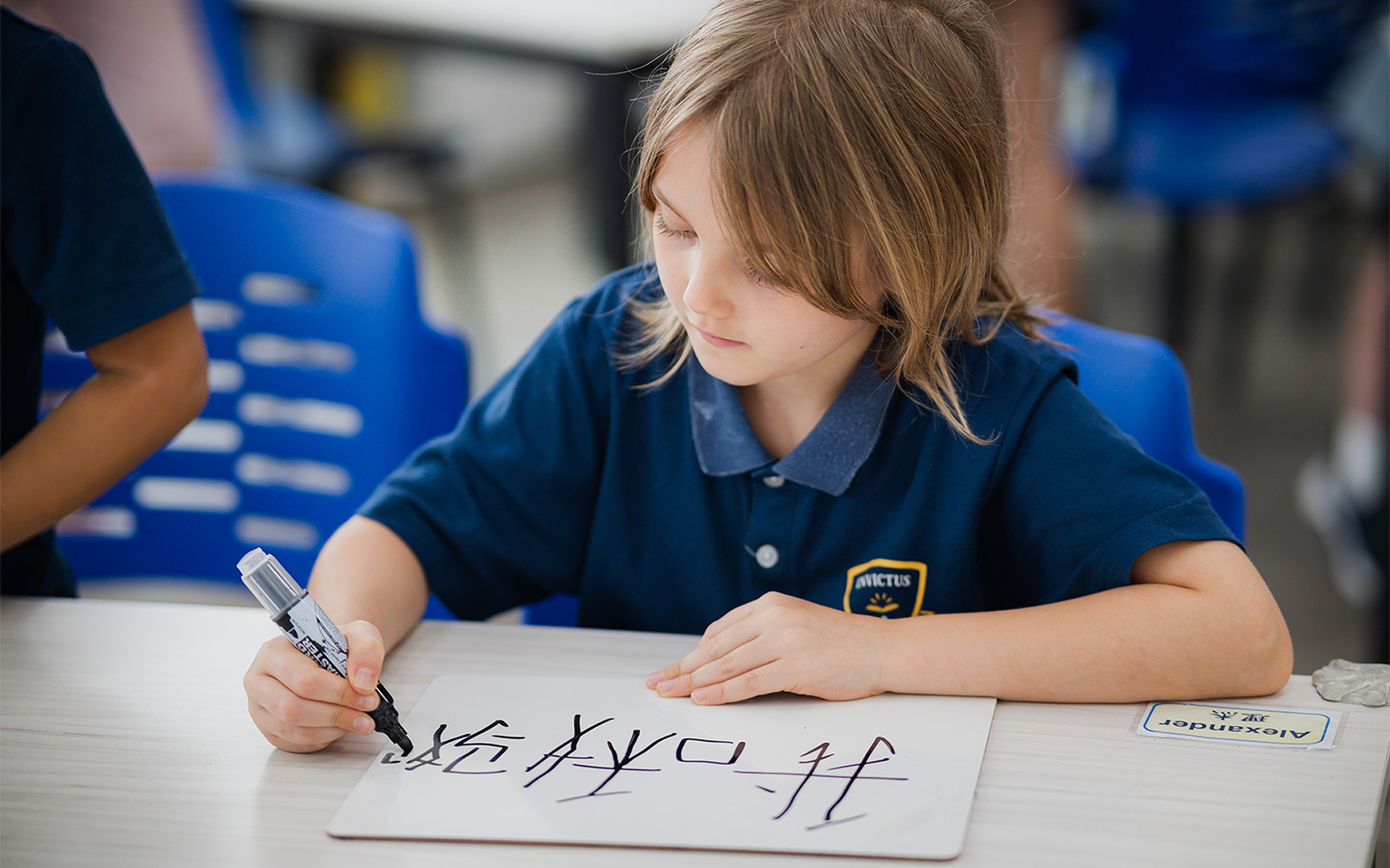 Student practicing writing Mandarin characters
