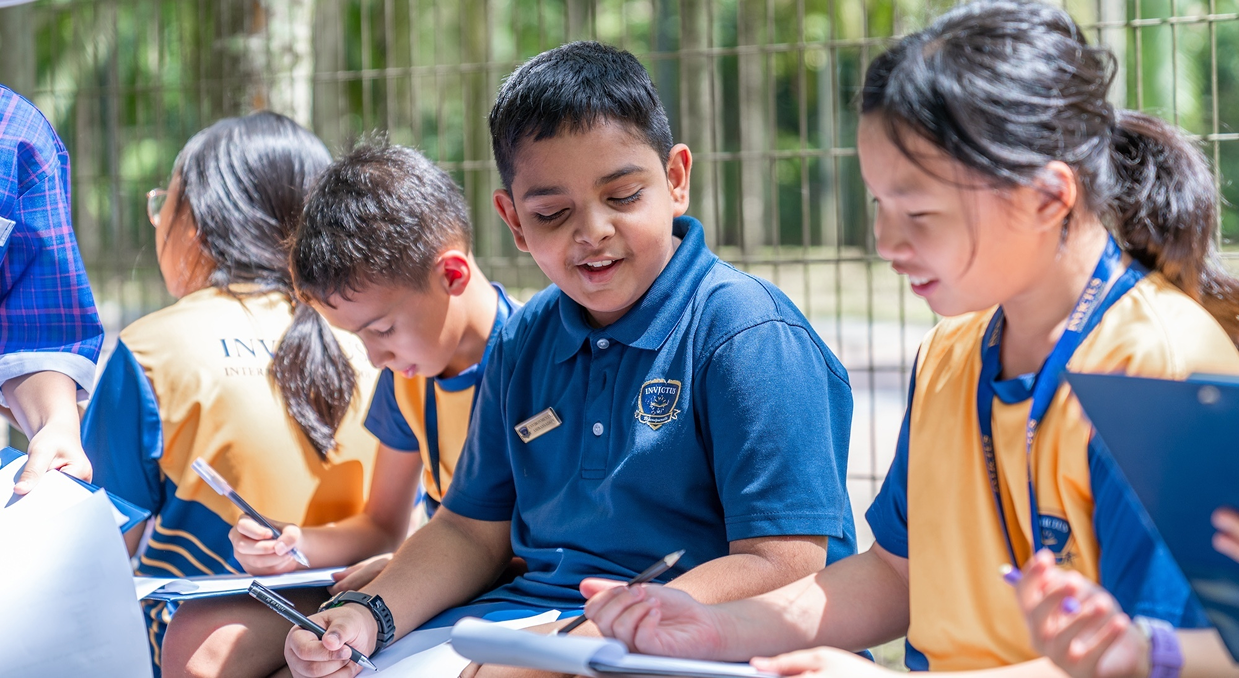 Group of children outdoors writing reflections