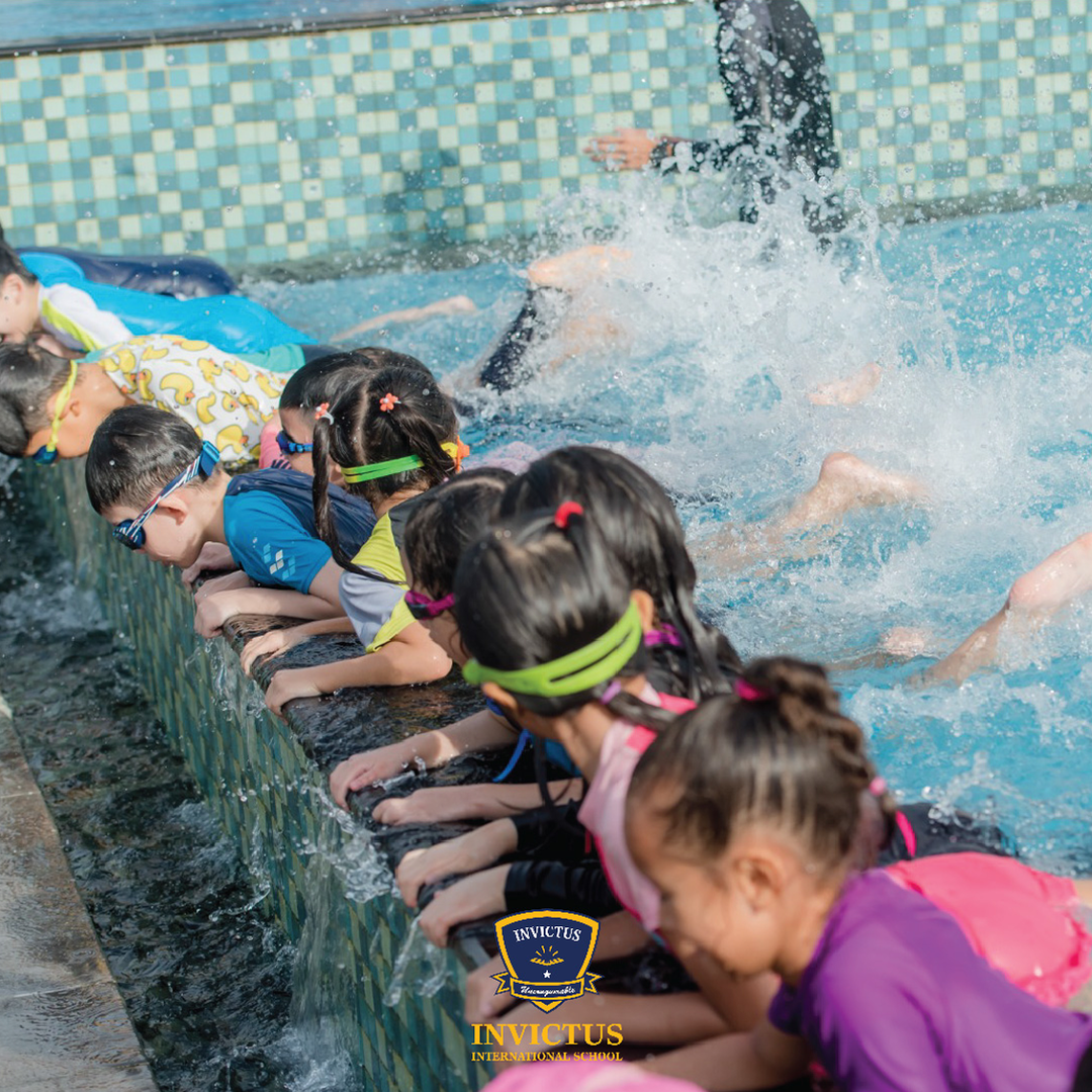 Invictus students swimming and splashing in water
