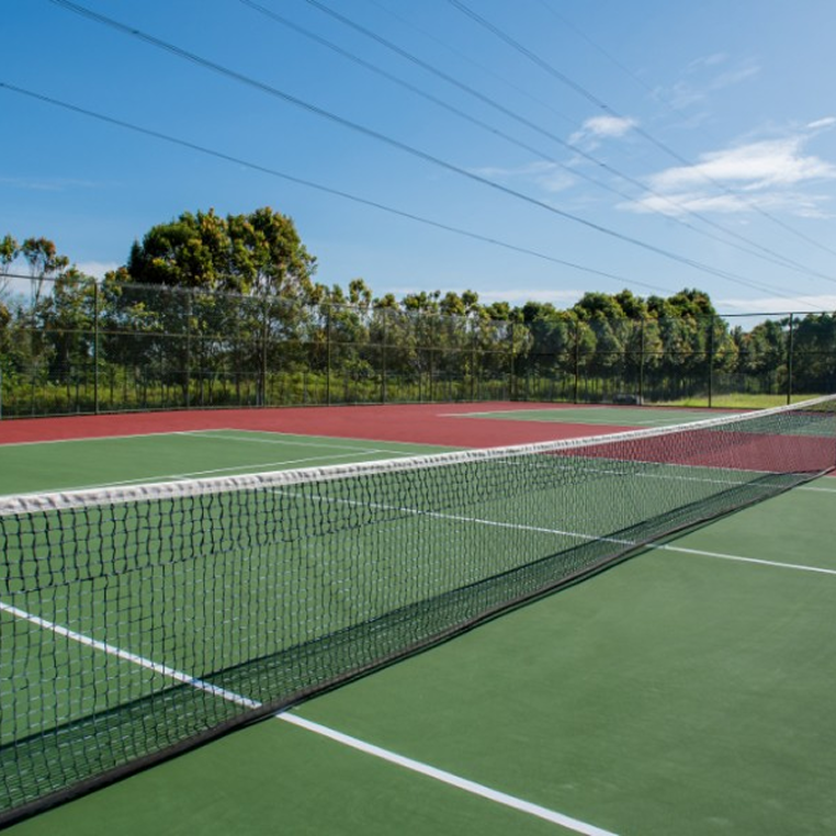 Invictus International School Malaysia Spring Hills Campus outdoor tennis courts surrounded by greenery