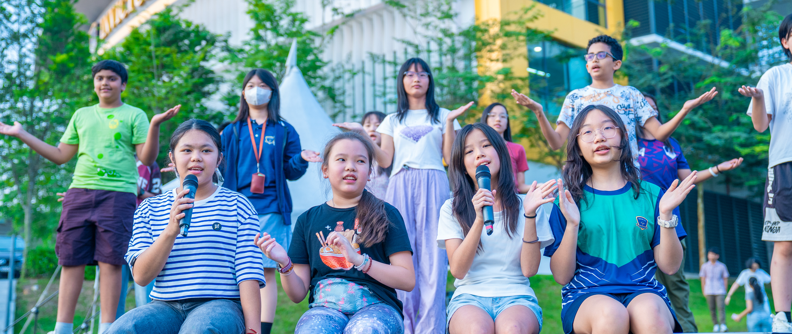 Students at Invictus Horizon Hills Malaysia enjoying outdoor activities with teachers, reflecting the joyful and diverse spirit of the campus.