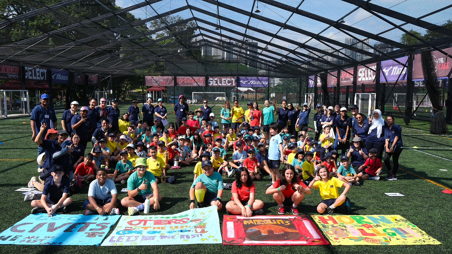 Group of Invictus International School Singapore primary students in uniform posing happily outdoors on a nature trail, showcasing school spirit, friendship, and a vibrant learning community.