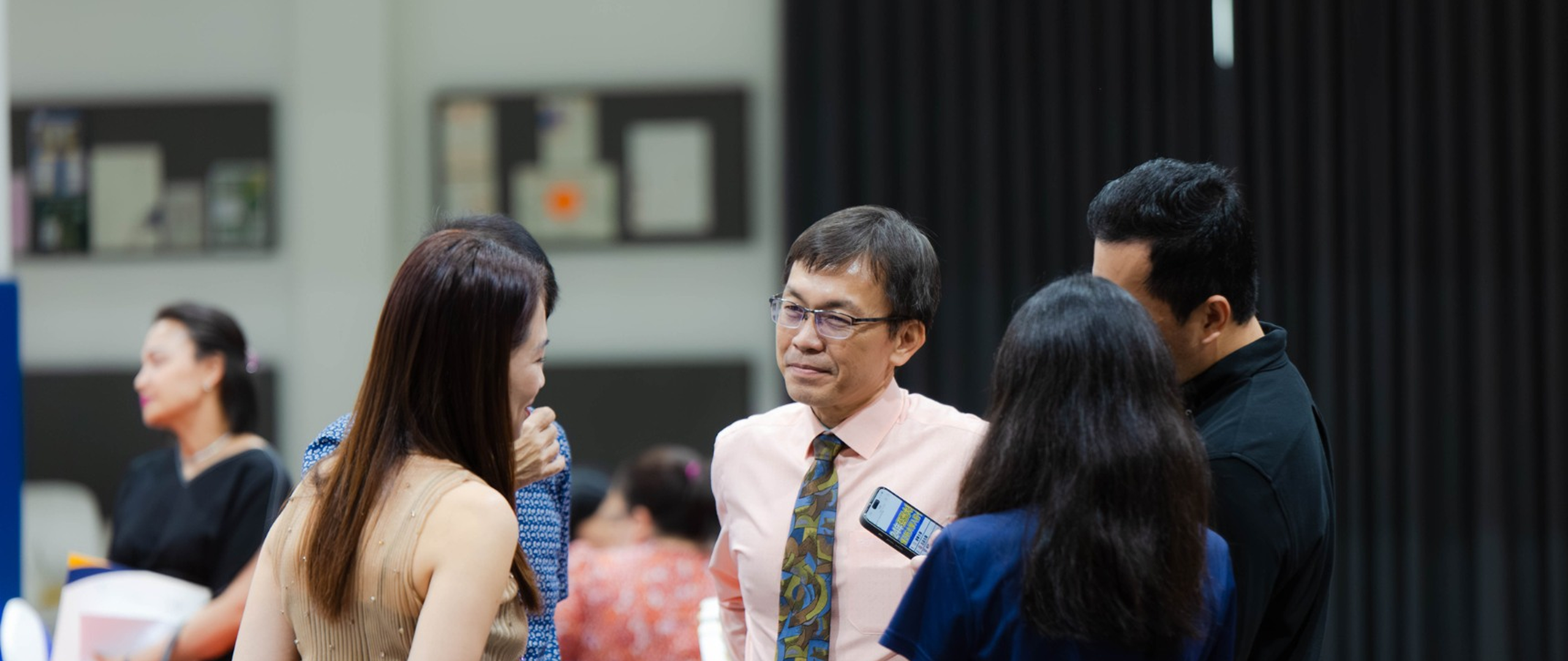 Parents and faculty engaging in a discussion during an open day or school event at Invictus International School Phnom Penh.