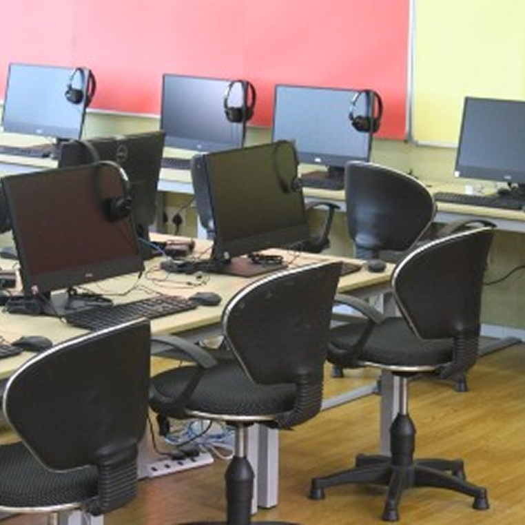 Invictus International School Malaysia Spring Hills Campus computer lab with desktop PCs and headsets on workstations