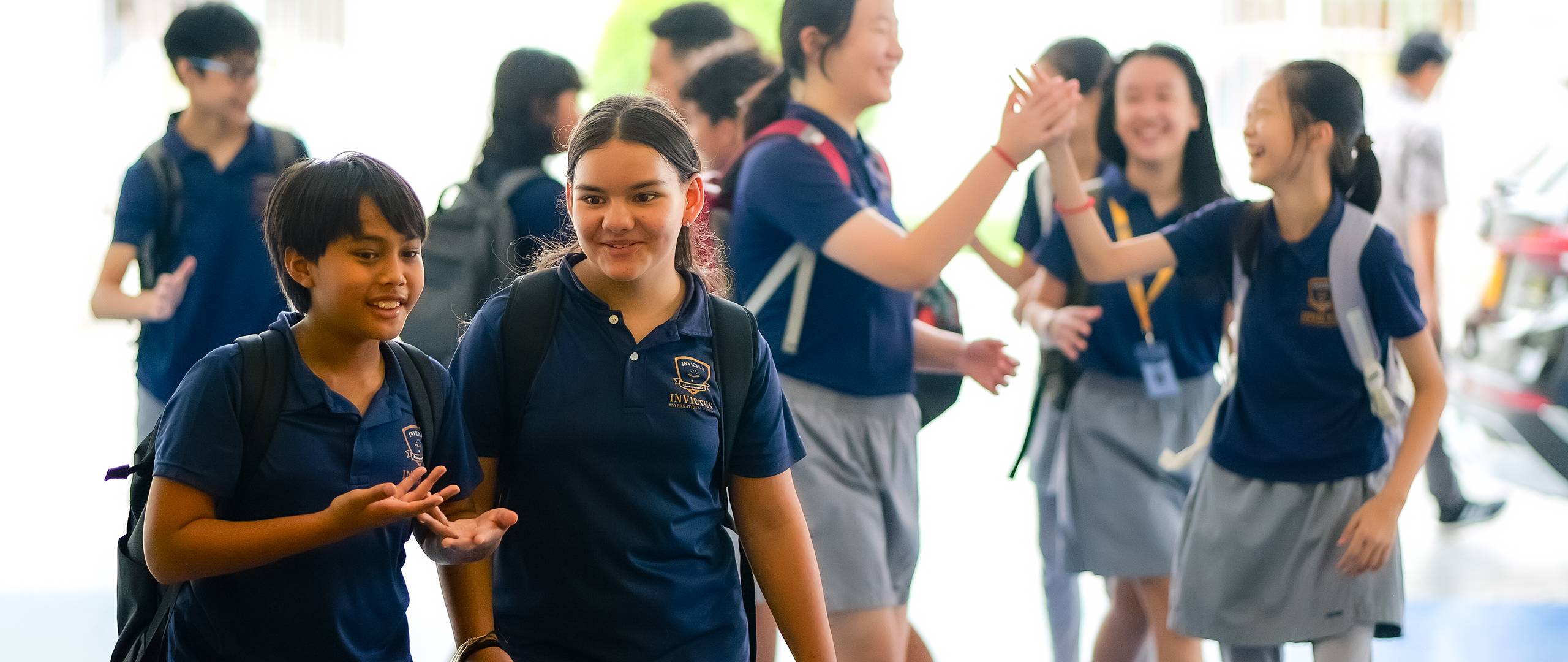 Four students performing a traditional dance