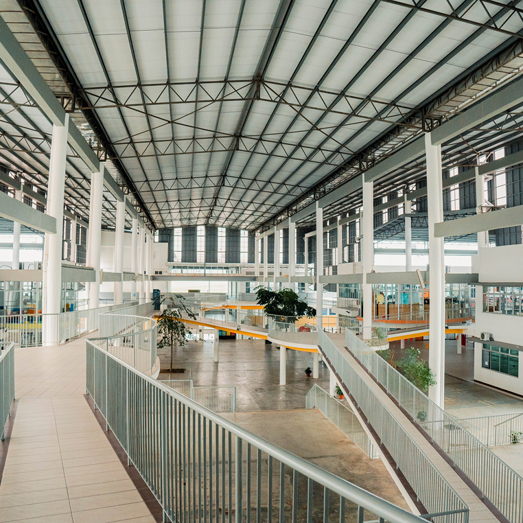 Invictus International School Malaysia Spring Hills Campus multi-level atrium with open walkways and high ceilings