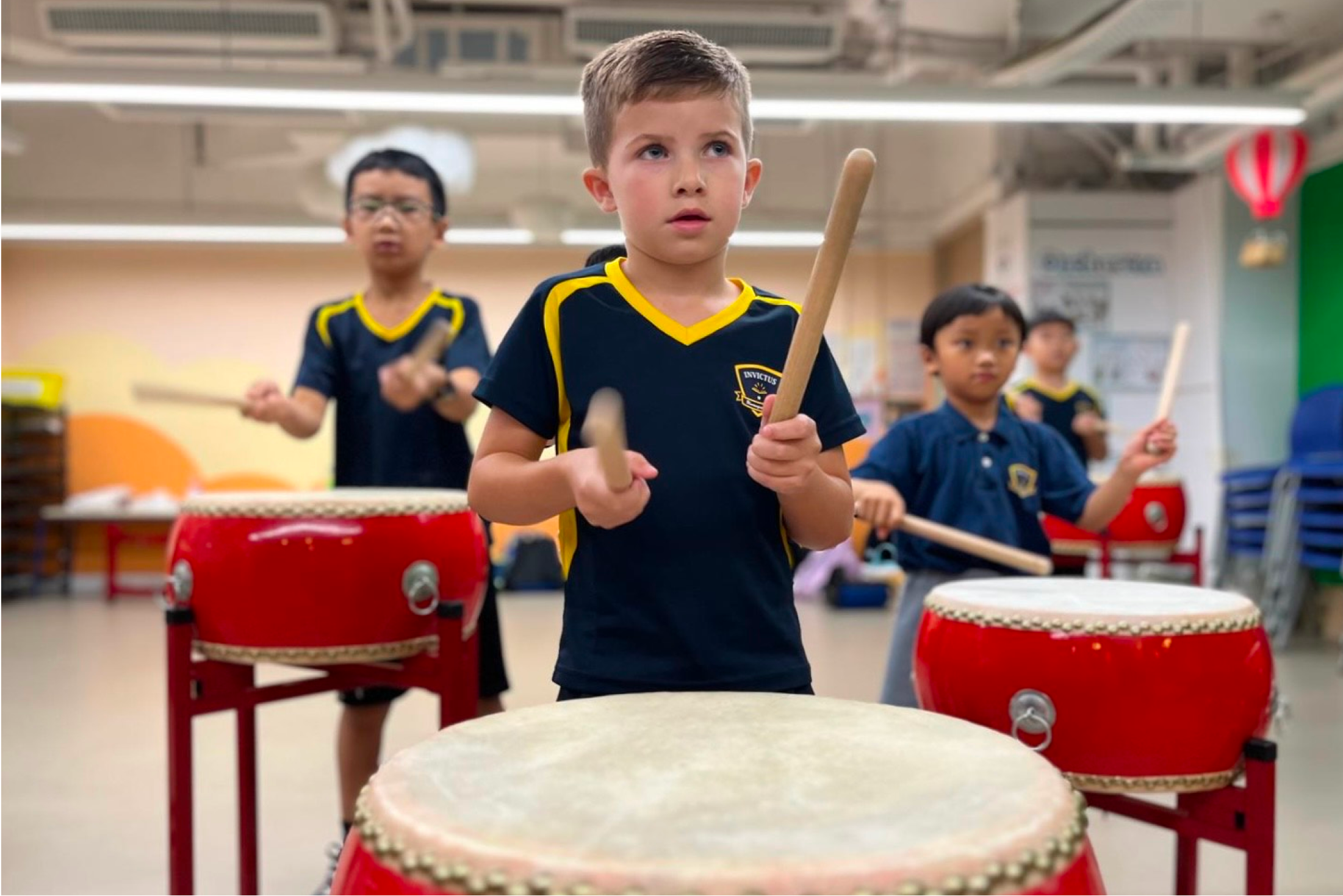 Young students playing percussion instruments in music class