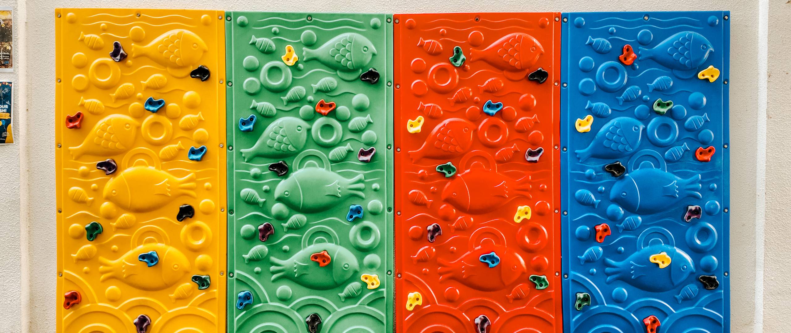 Green and welcoming courtyard with bright yellow hexagonal tiles and circular planter seating at Invictus International School Phnom Penh.