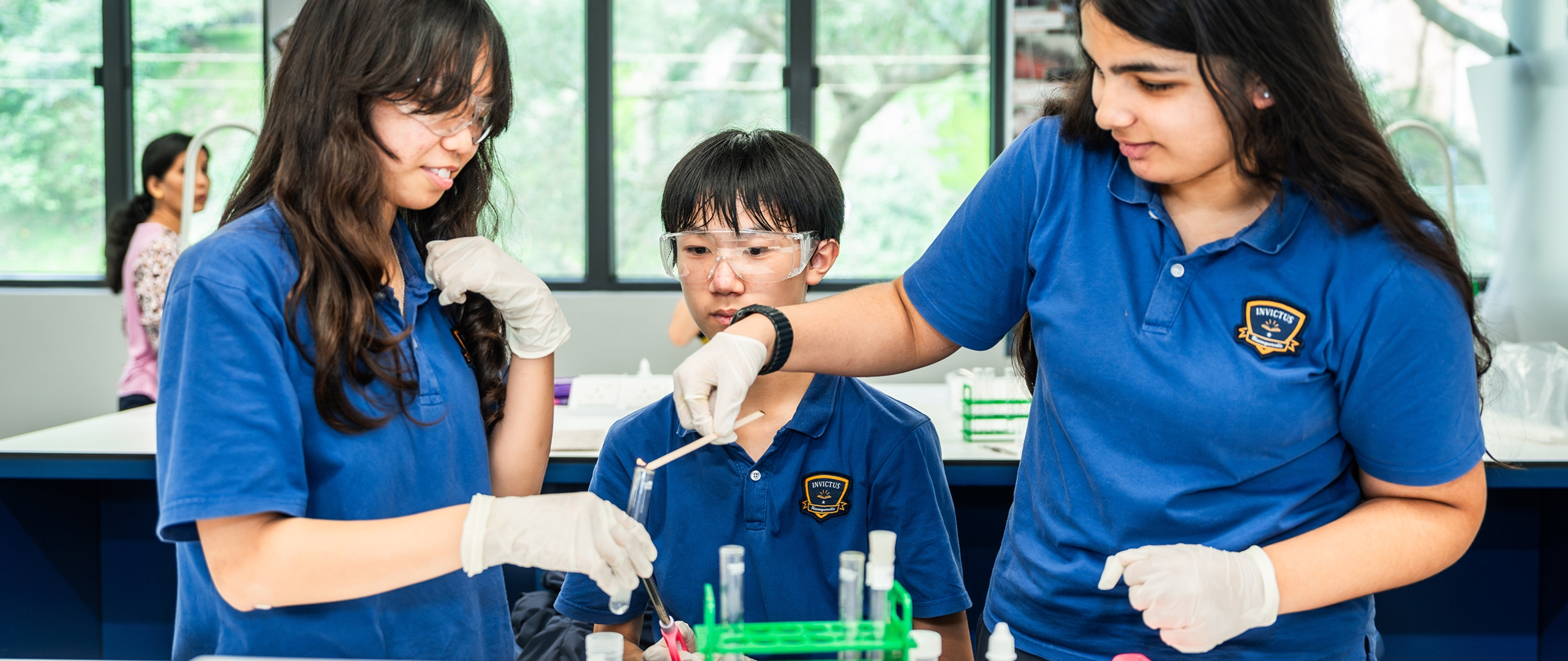 Three students learning in a chemistry lab