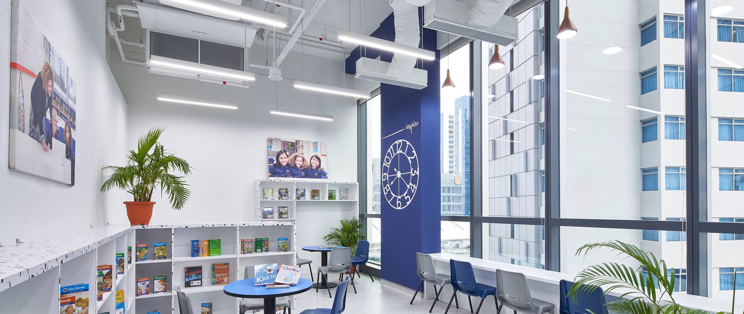 Invictus Centrium Square school library with bookshelves, seating areas, and a vibrant reading corner.