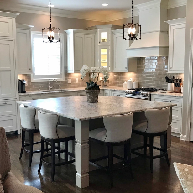 White painted kitchen cabinetry with beige painted island