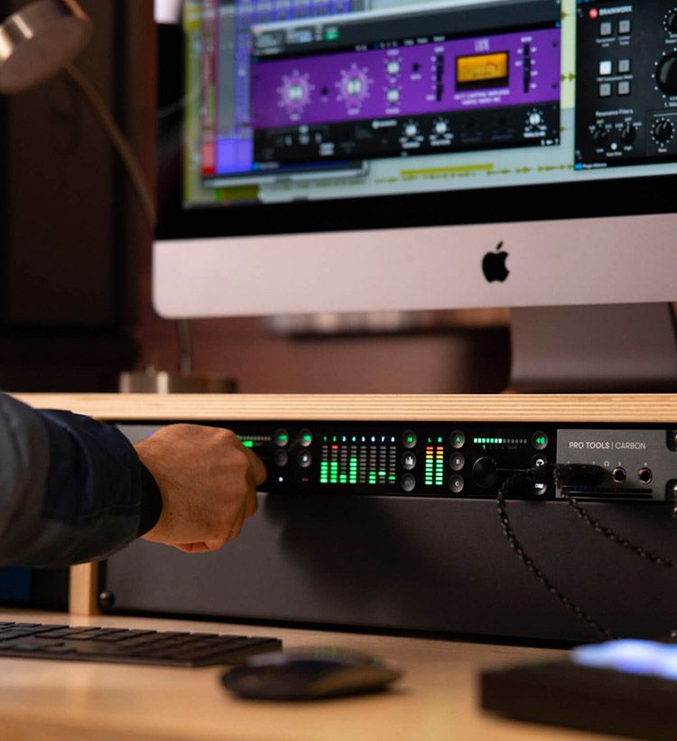 Close up of hand controlling the Pro Tools Carbon audio interface
