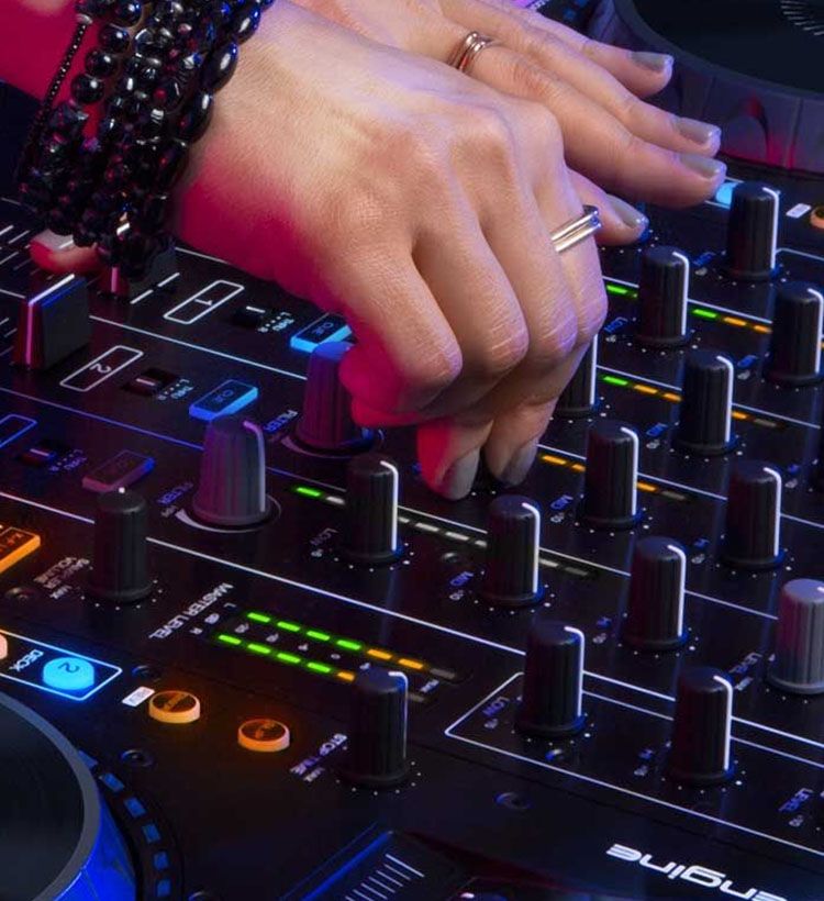 Close up of girl's hands using Denon mixer