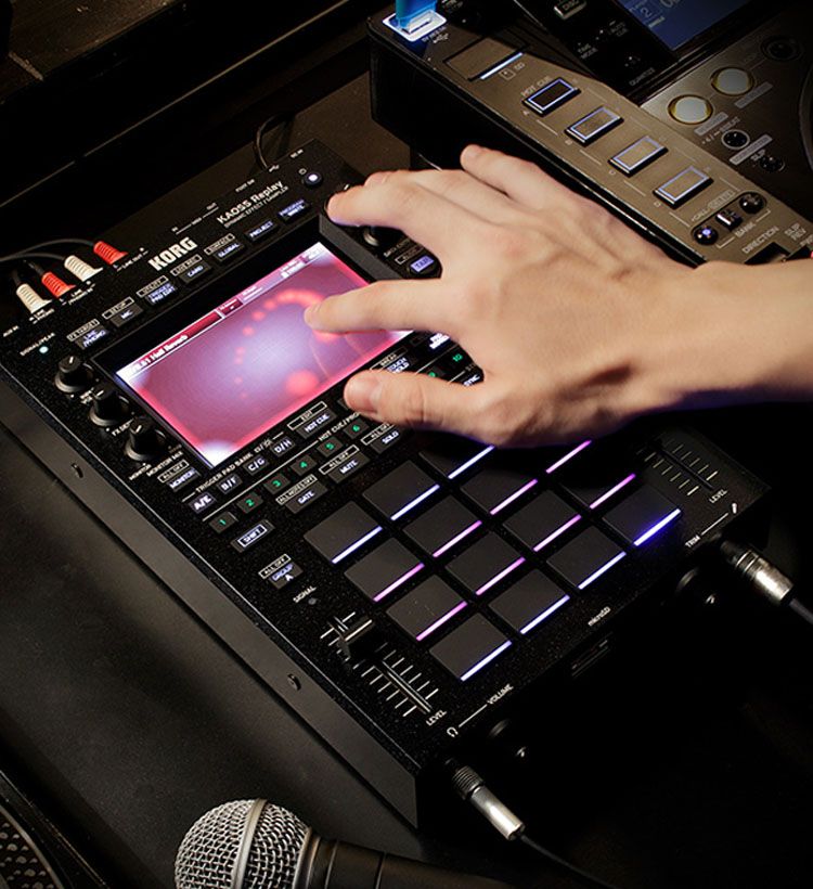 Close up of hand playing Korg sampler touchpad