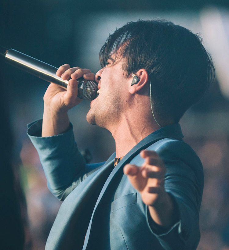 Singer on stage with in-ear monitors