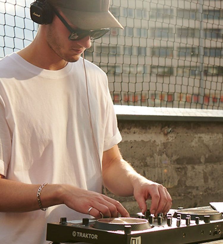 Guy DJing outdoors with Native Instruments DJ controller
