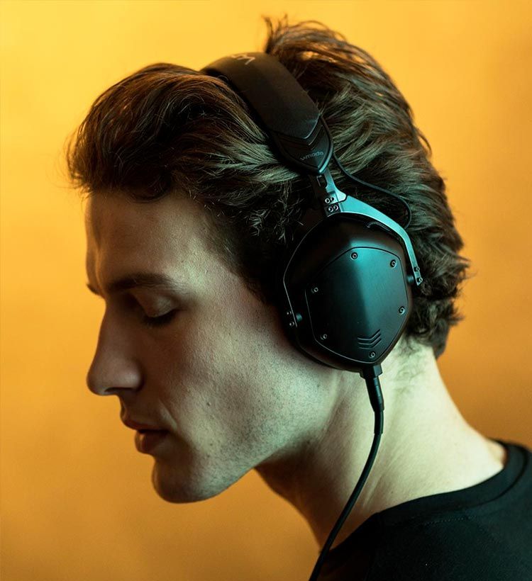 Close up of man enjoying music on V-Moda headphones