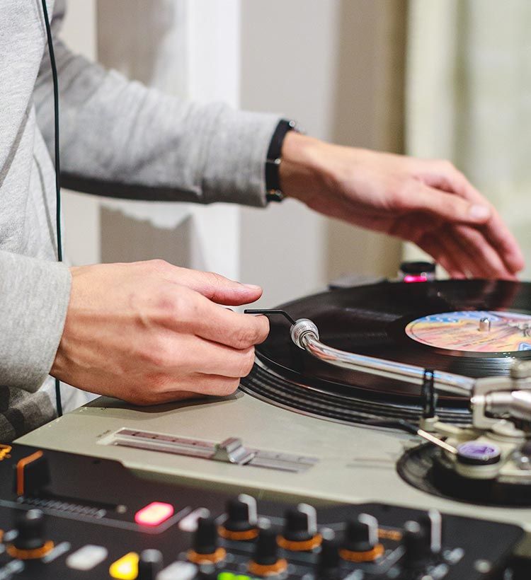 Close up of DJ placing stylus on record on Technics turntable