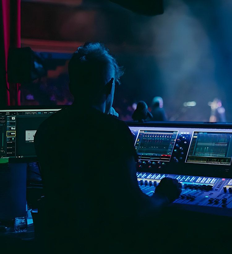 Man at mixing desk mixing live during a concert