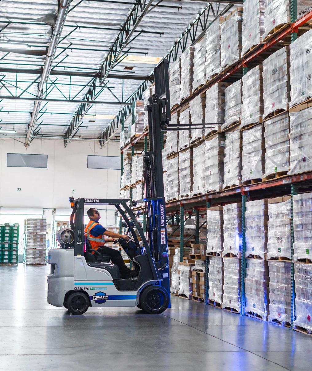 CASAS International warehouse forklift operator lifting the forklift to access a pallet