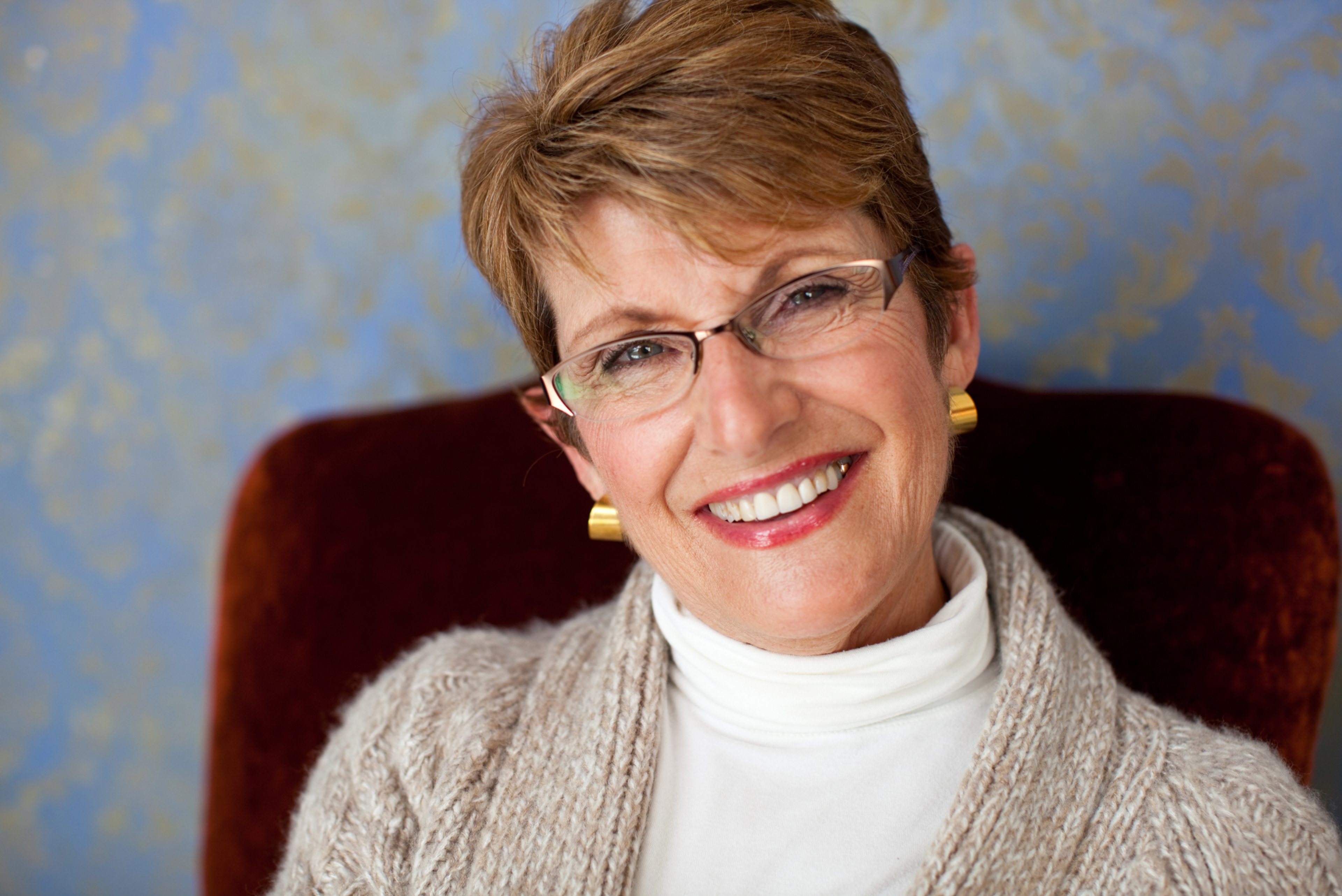 Woman in her 60s with a confident smile after exploring NHS dental implant eligibility