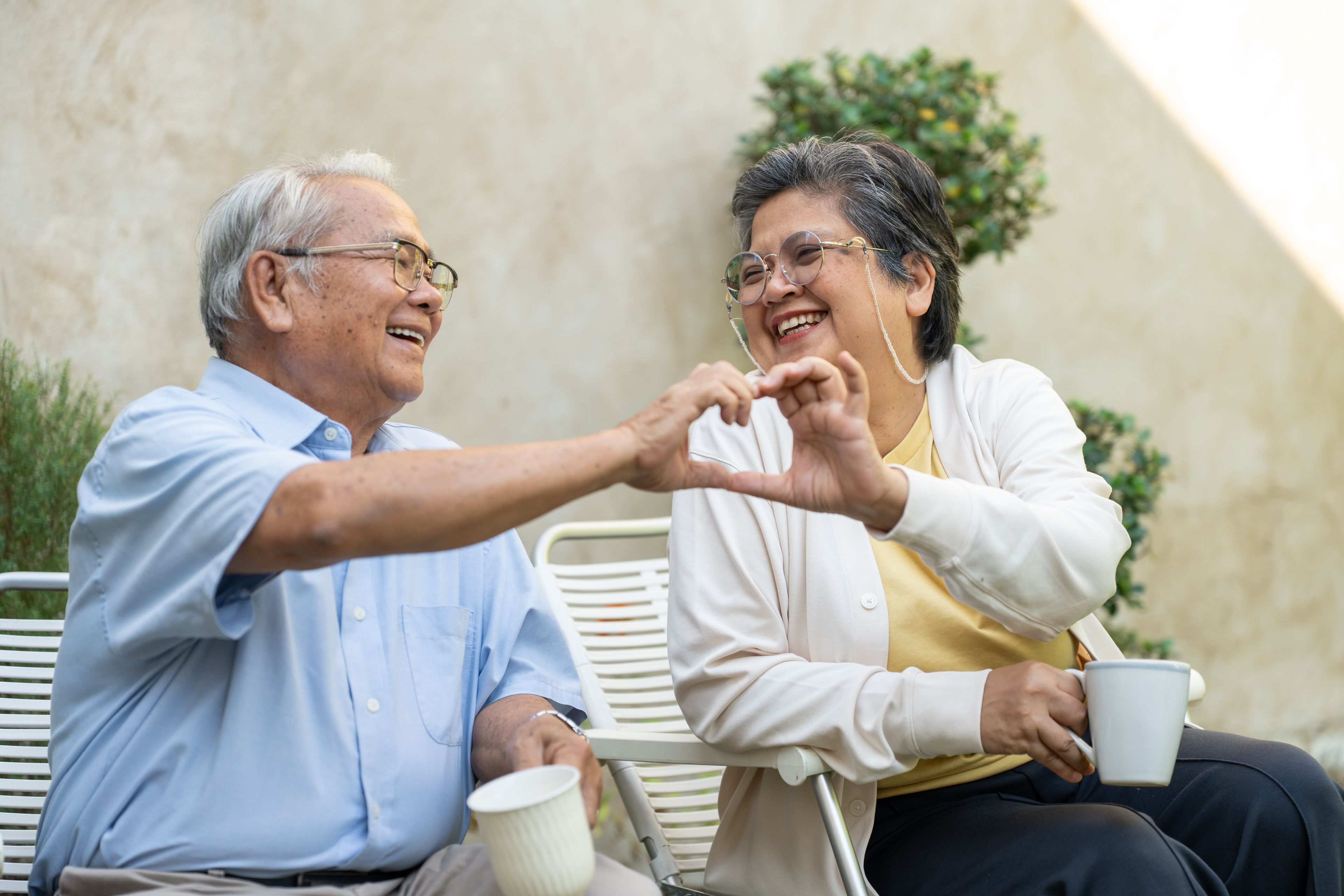 Happy couple comparing dental implants in the UK versus treatment abroad in Turkey