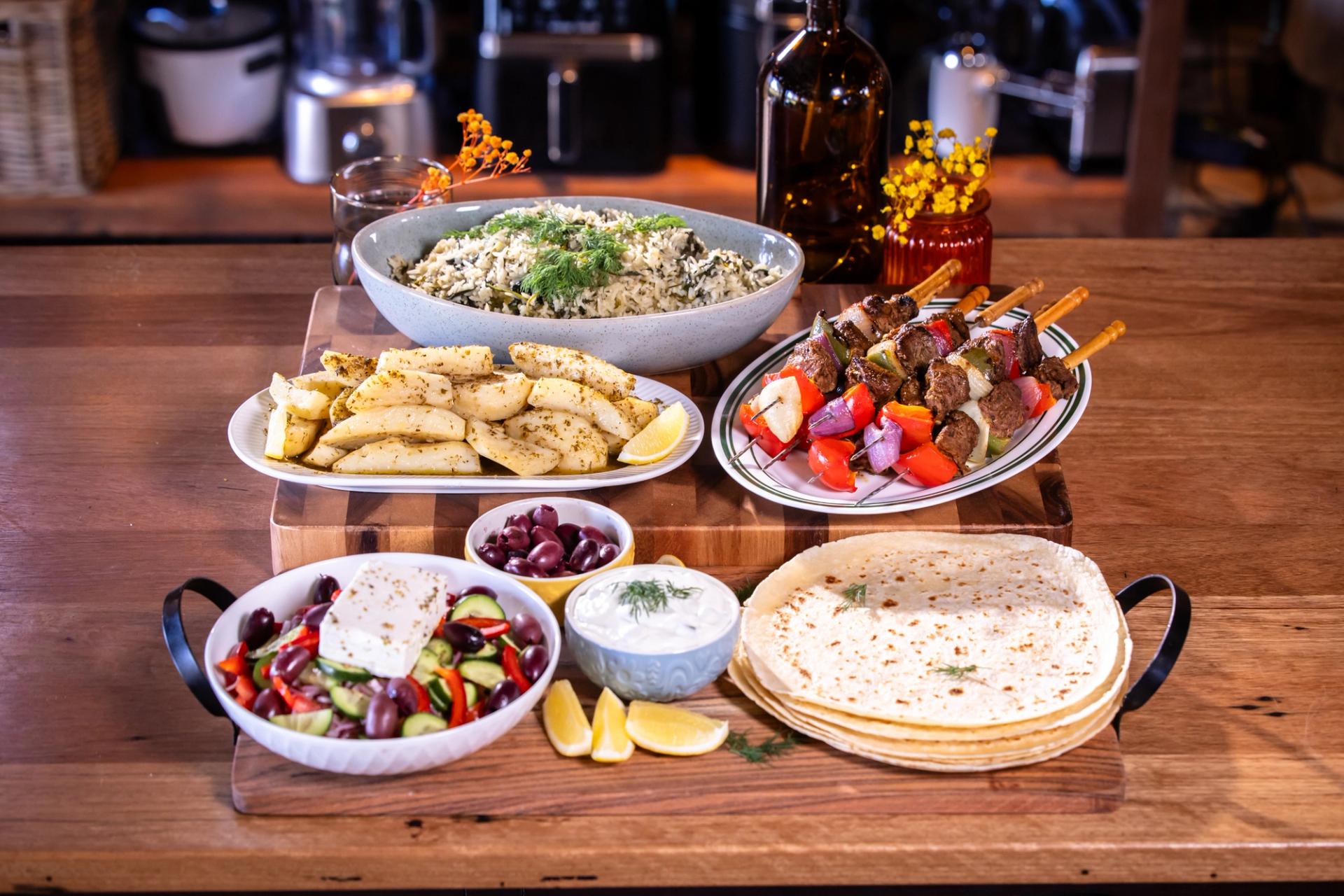 Greek feast spread with lamb souvlaki