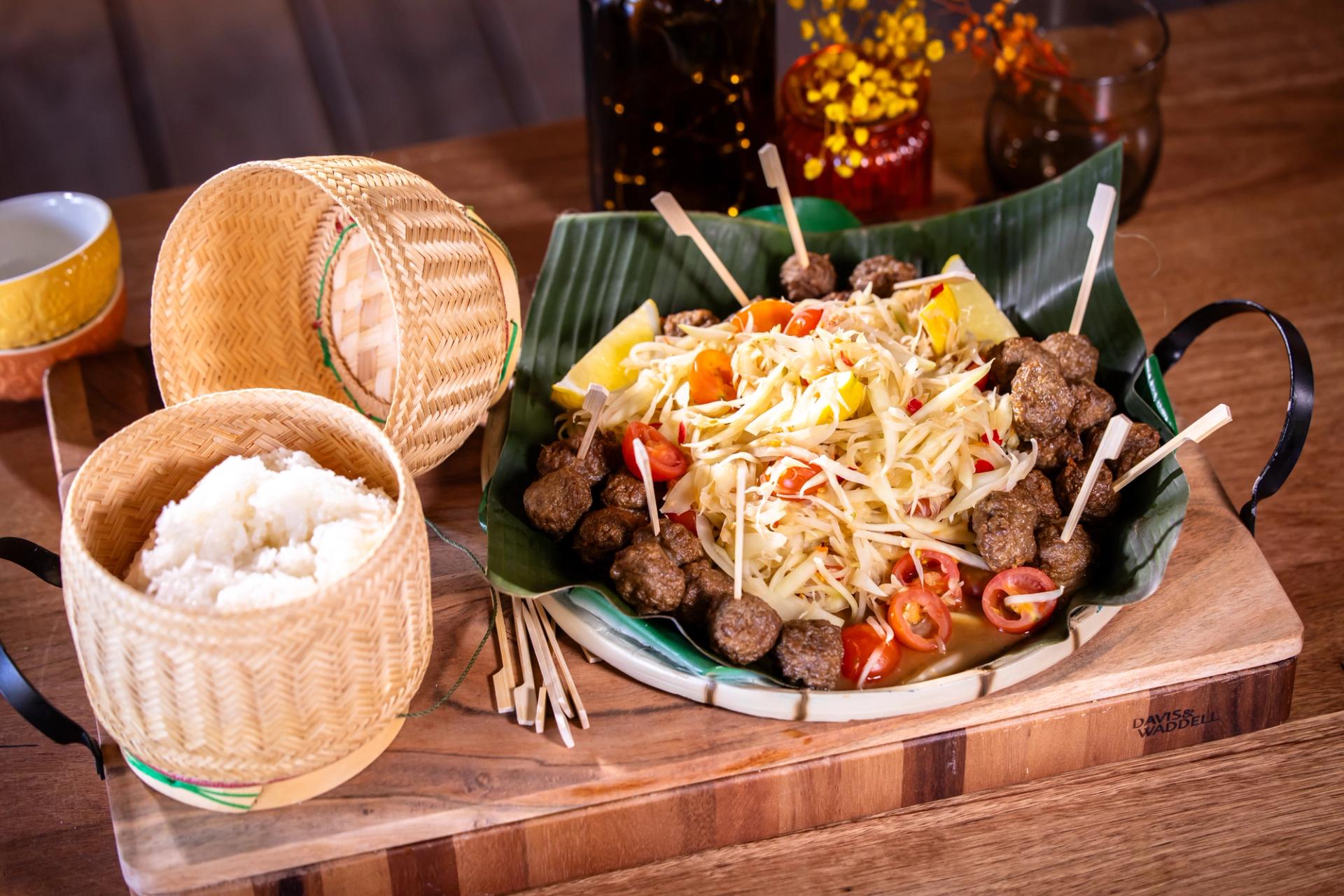 Lao papaya salad with meatballs and sticky rice