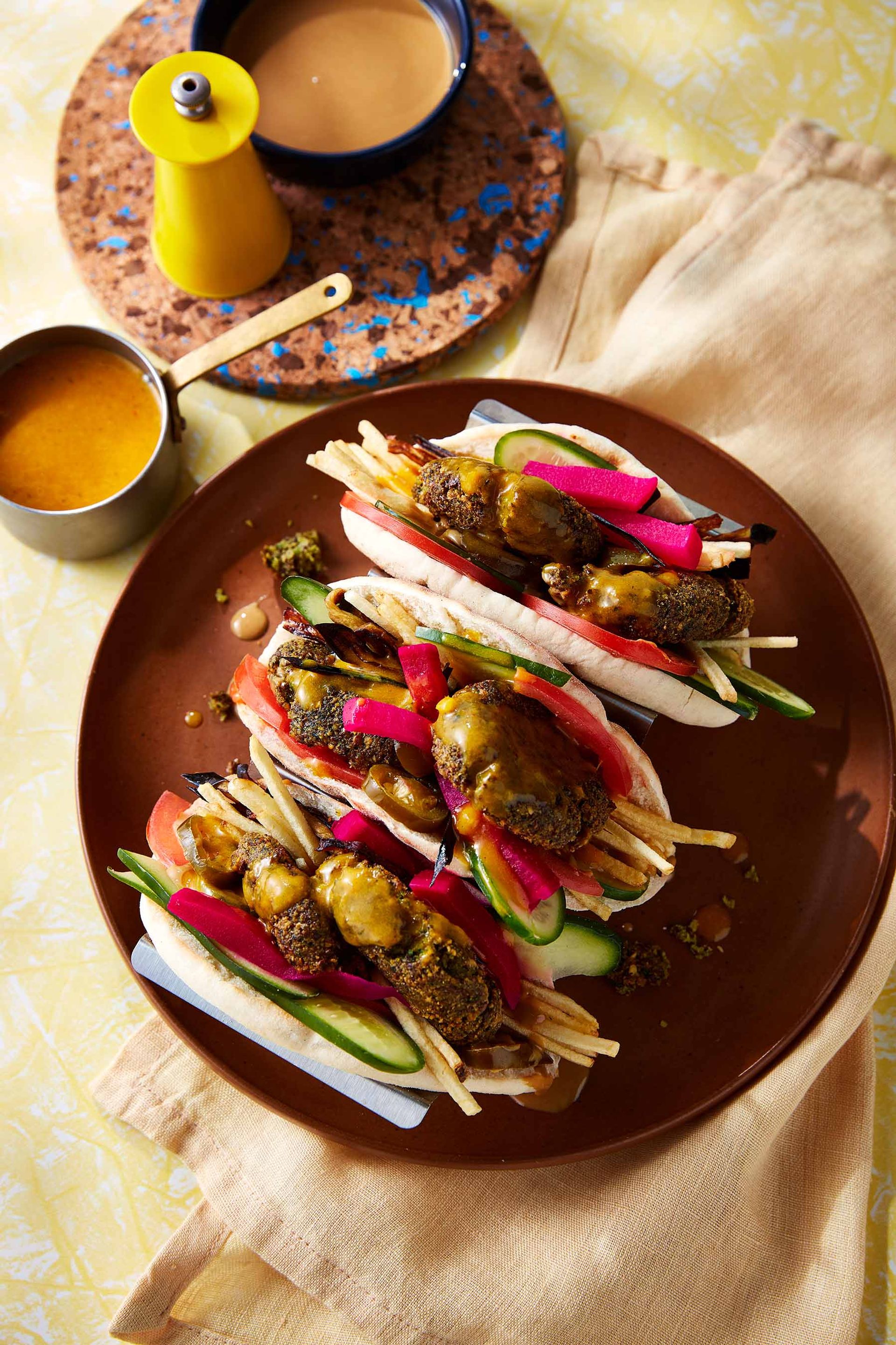 Three falafel sandwiches on a plate